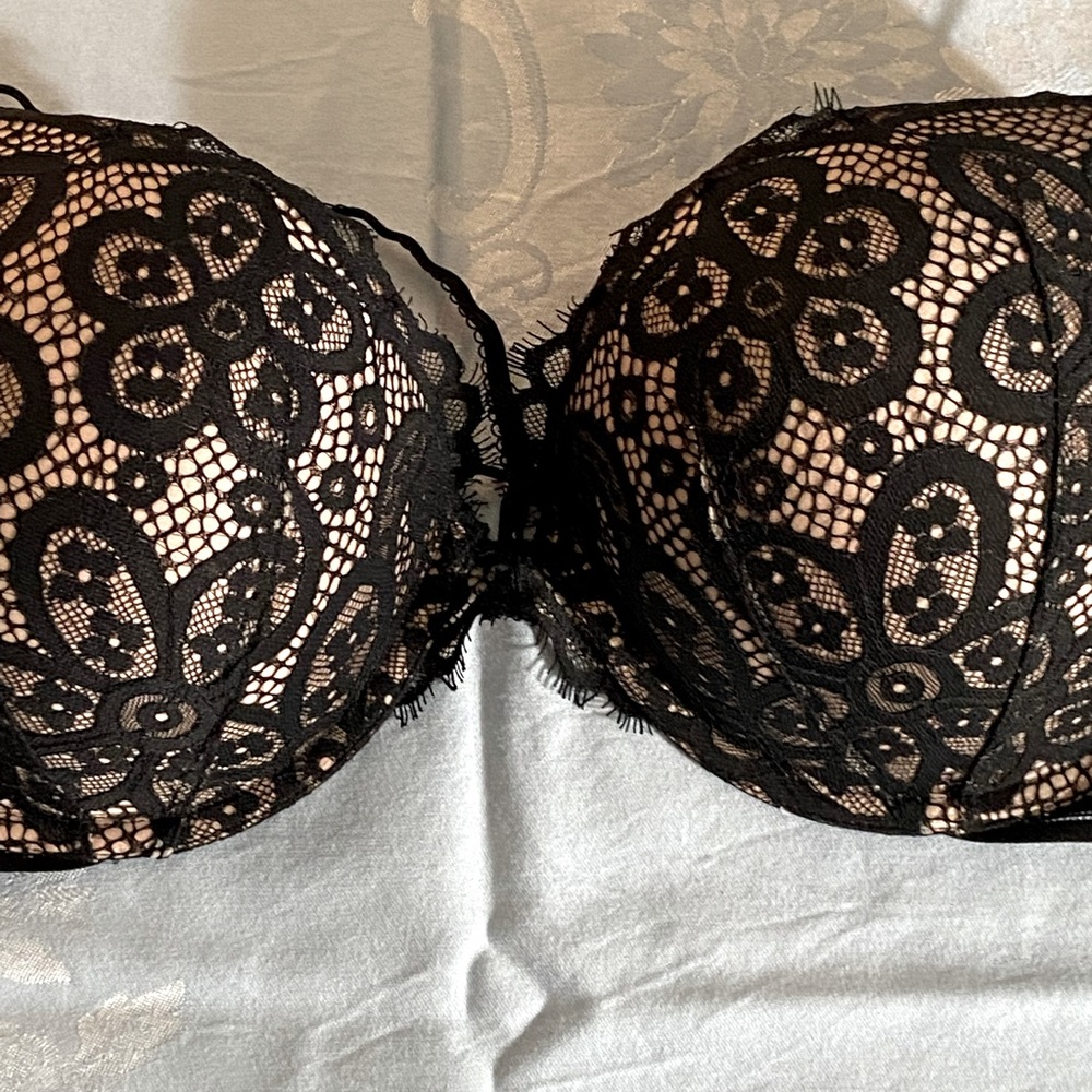 Victoria’s Secret 38D nude with black lace bra.
